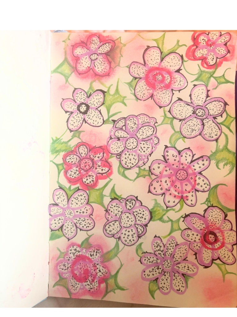 Image from sketchbook, flowers with black dot detailing inside, with pink, green, and purple designs surrounding it.